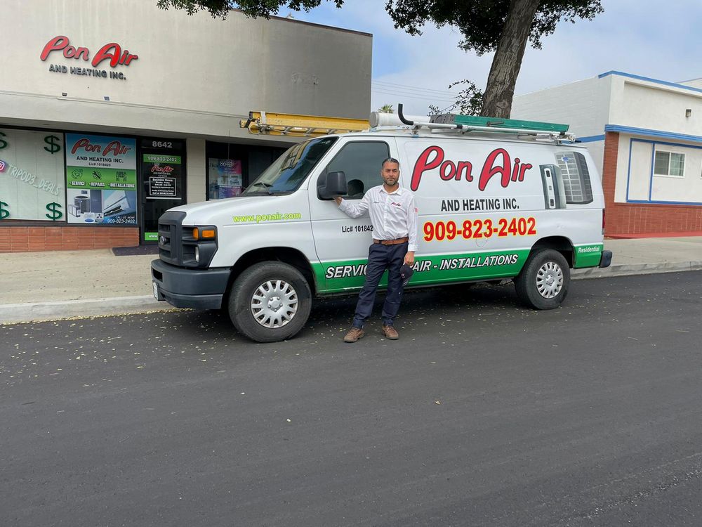 A Pon Air technician beside a company van outside the Fontana shop.